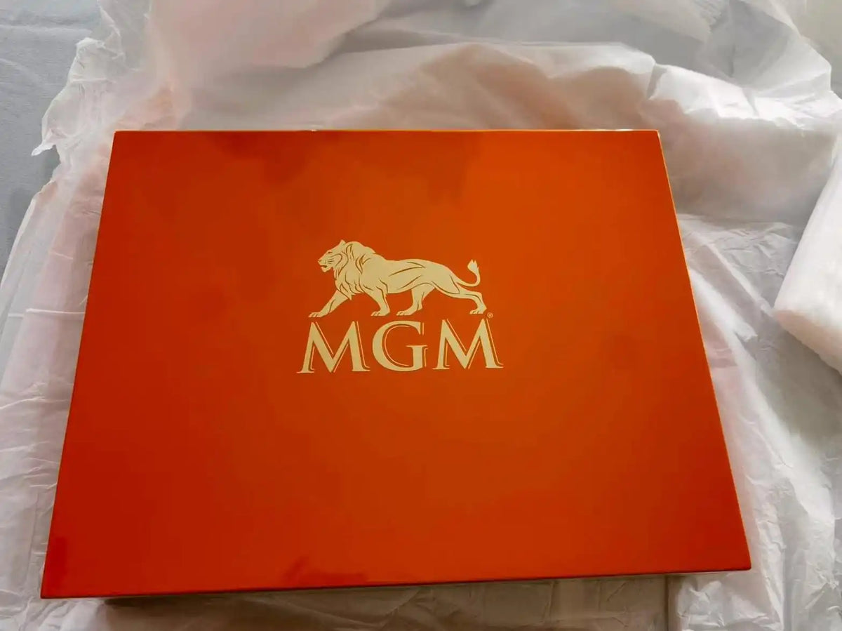 Custom wooden presentation box lid engraved with the MGM logo